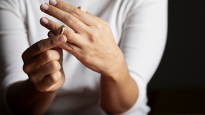 Woman contemplating divorce while she twists her wedding band on her finger