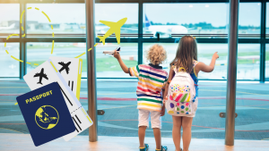 A young boy and his sister await their airplane as they look out an airport window